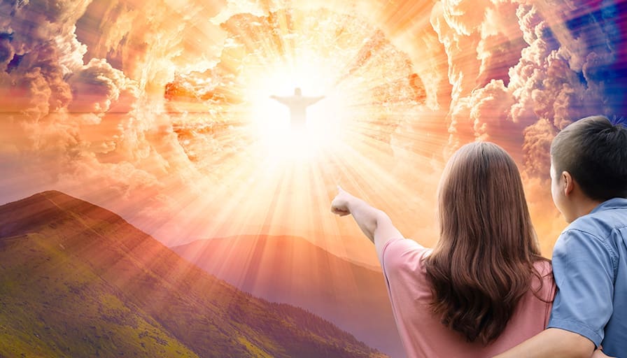 A woman and child stand on a mountainside, looking and pointing toward a radiant figure of Jesus appearing in the clouds with bright golden light shining through the sky.
